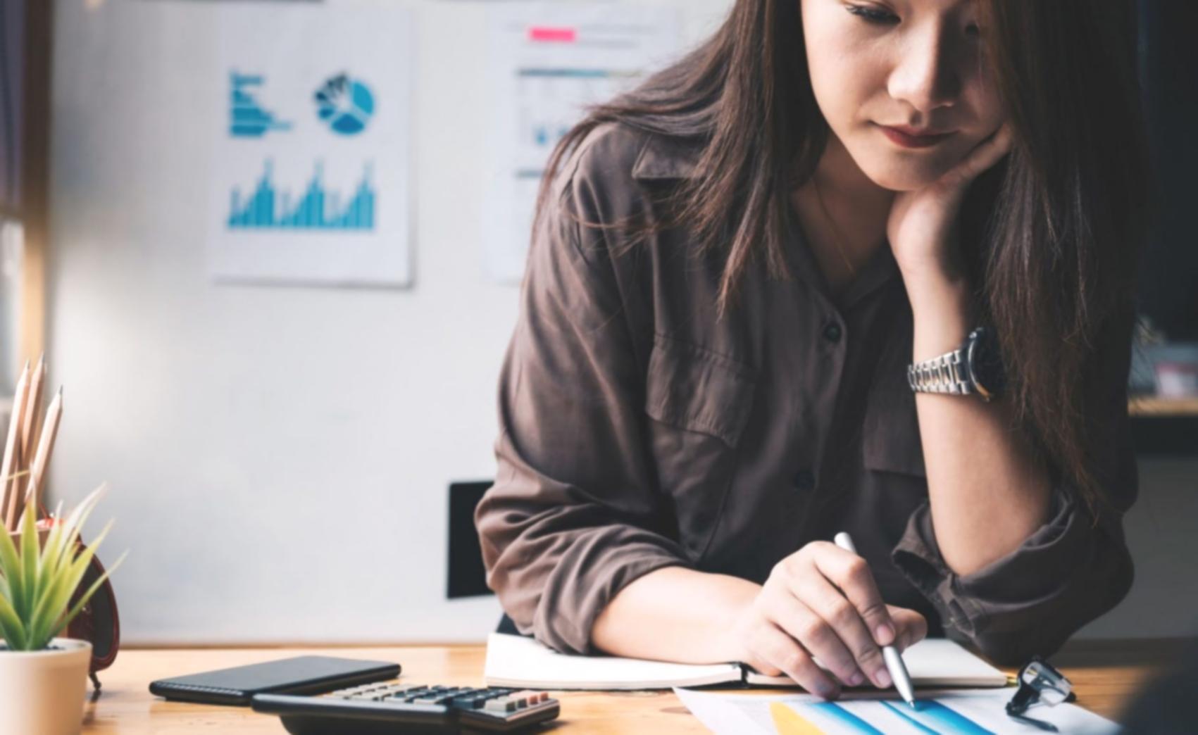 Modern workspace with analytical dashboards and financial data visualization